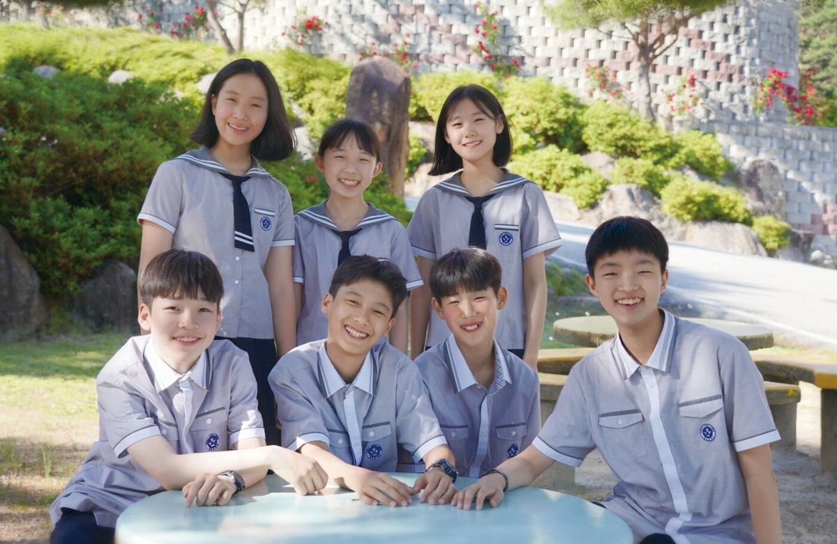 교정에서 밝게 웃는 링컨중고등학교 학생들